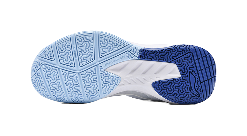 Blue and white badminton shoe outsole with tread pattern and hex-like traction