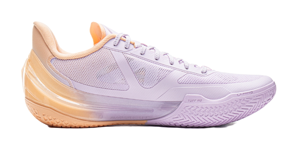 Lavender basketball shoe with perforated panels and orange-edged sole.