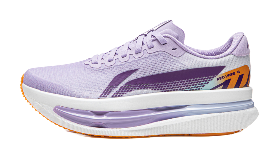 Women’s low-top running shoes in lavender with purple logo and orange outsole