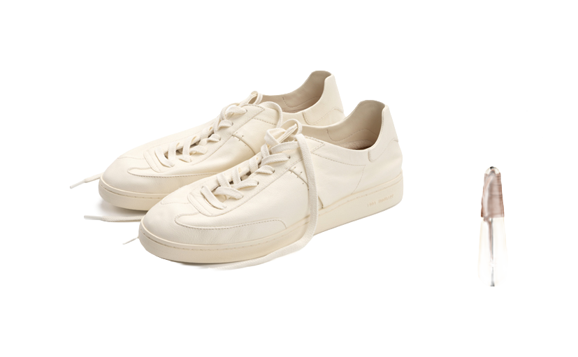 Unisex antique white lace-up trainers, angled close-up