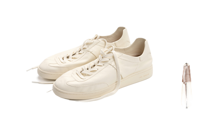 Unisex antique white lace-up trainers, angled close-up