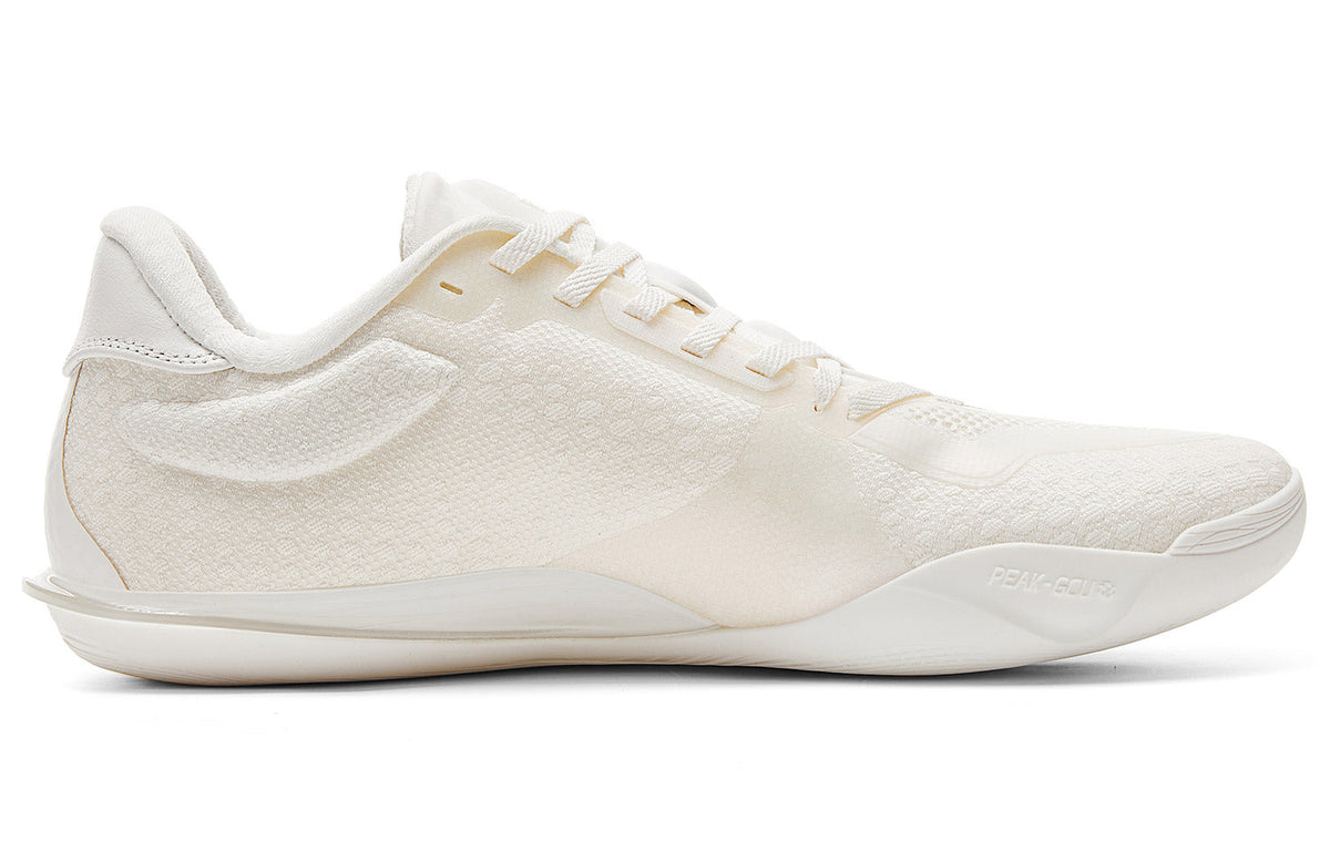 Milky white low-top basketball shoe side view with lace-up closure and padded collar