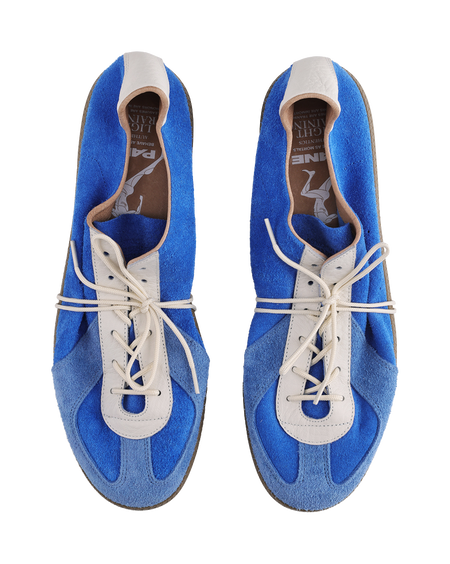 Two blue sneakers showing inner lining with white lace setup and brown footbed.