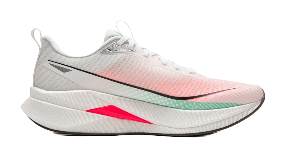 Running shoe side view in white and light pink with black logo, green trim, red wedge midsole