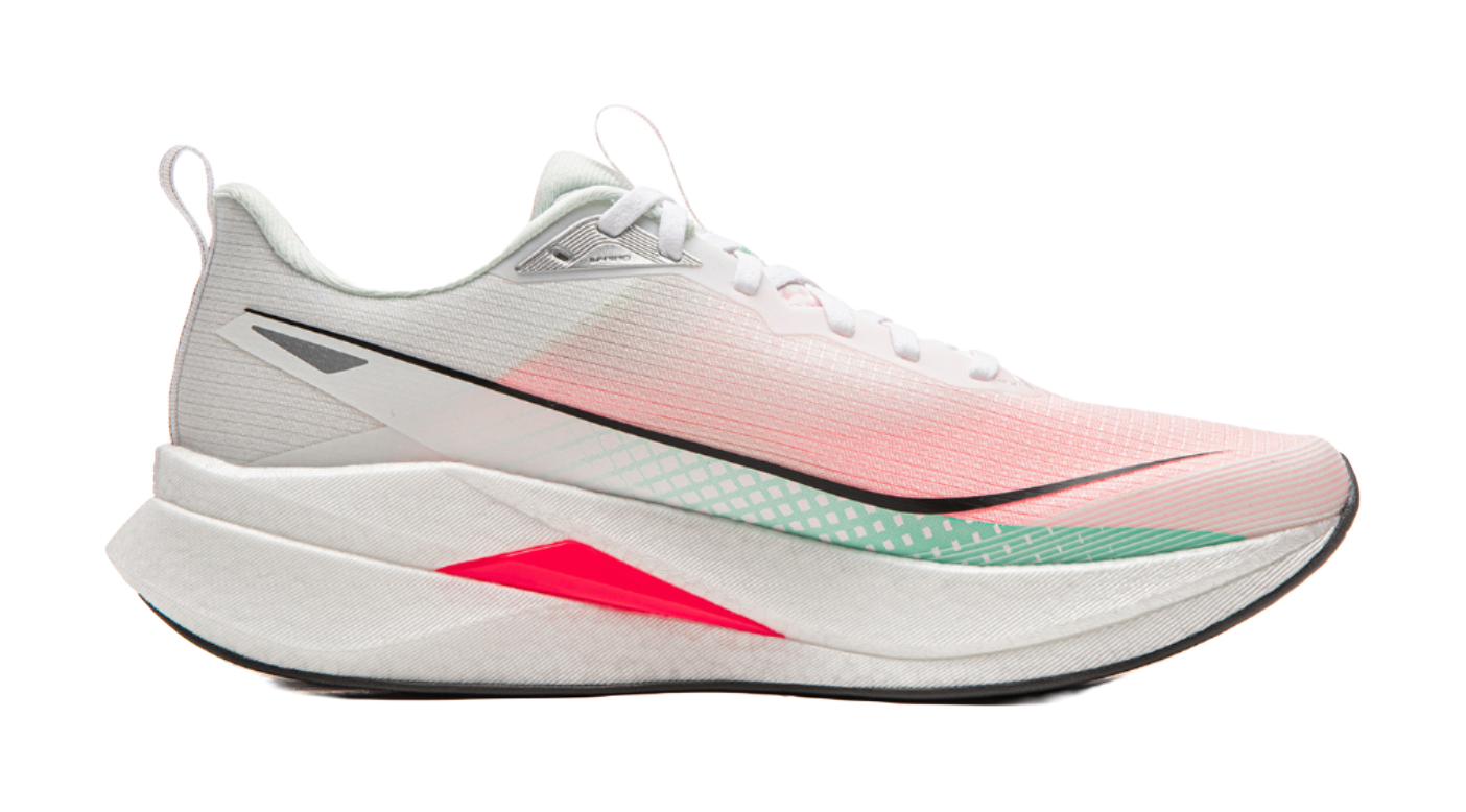 Running shoe side view in white and light pink with black logo, green trim, red wedge midsole