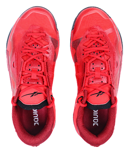 Red low-top basketball shoes, front view with red laces and padded tongue