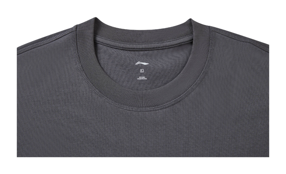 Gray crew-neck T-shirt close-up with small chest logo