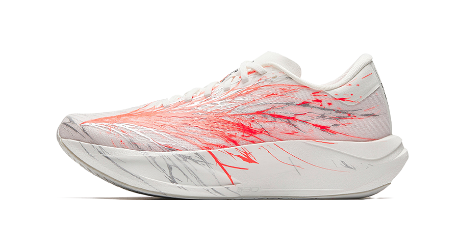 White running shoe with red patterned upper, lace-up front, light gray sole