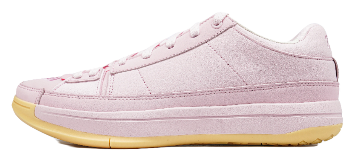 Pink low-top basketball shoes with white laces and textured gold rubber outsole