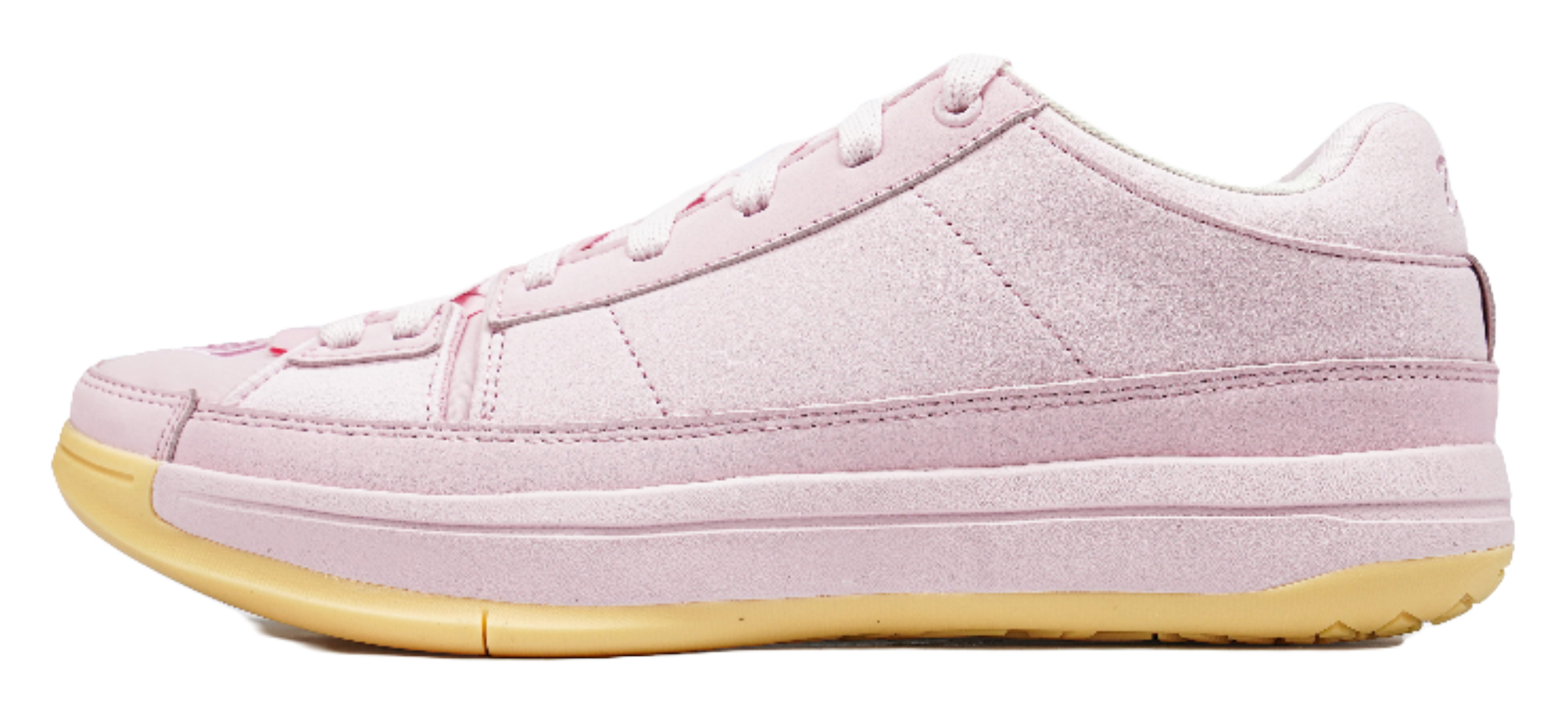 Pink low-top basketball shoes with white laces and textured gold rubber outsole