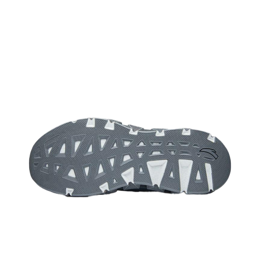 Gray outsole with tread pattern and small raised branding on running shoe