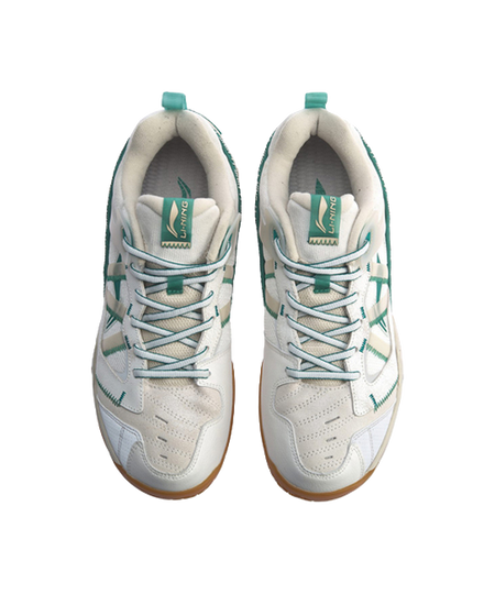 White-and-gray badminton shoes, front view pair, green lace loops and tongue labels