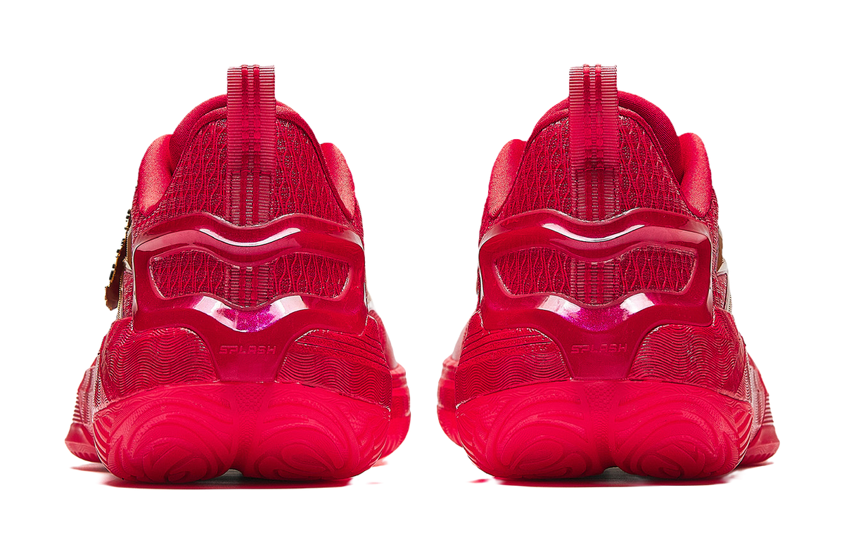 Pair of red basketball shoes with cushioned tread sole and rear pull-tab heels.