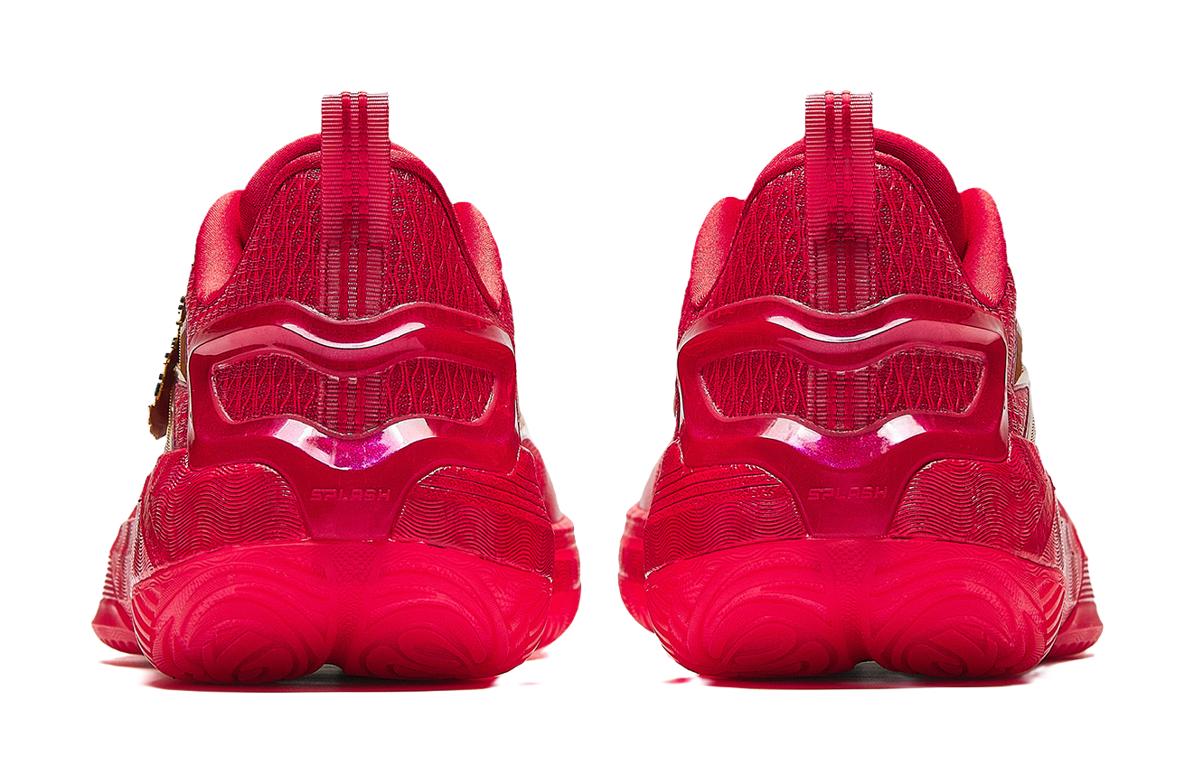 Pair of red basketball shoes with cushioned tread sole and rear pull-tab heels.