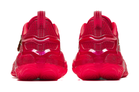 Pair of red basketball shoes with cushioned tread sole and rear pull-tab heels.