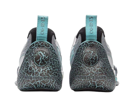 Heel view of gray blue basketball shoes with teal pull tabs and textured navy panels