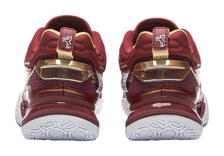Red badminton shoe back view with strap tab, heel cushioning, and white tread outsole.