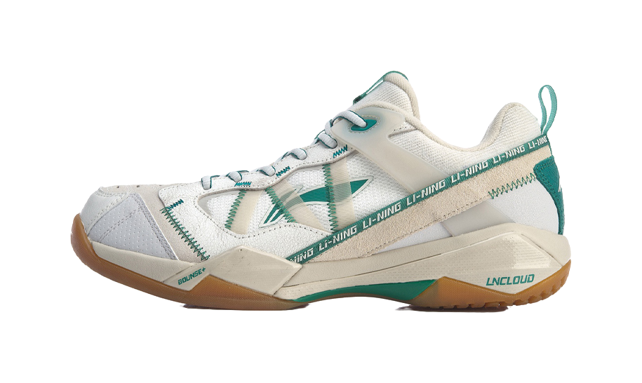 White-and-gray badminton shoe with green accents, side logo, lace-up design