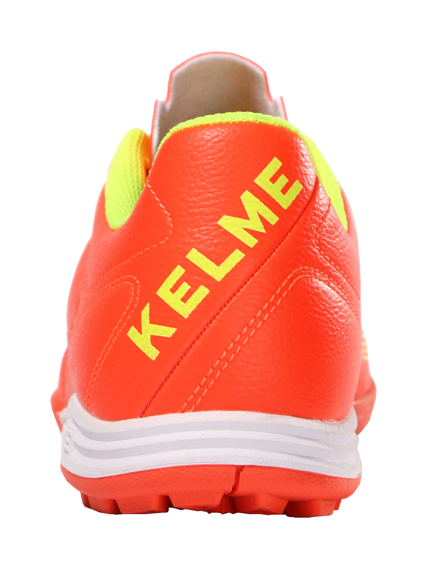 Orange heel and back of TF training soccer shoe with KELME lettering and cushioned collar