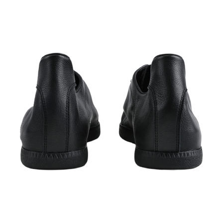 Black low-top training sneakers shown at the back with cushioned heel and rubber tread.