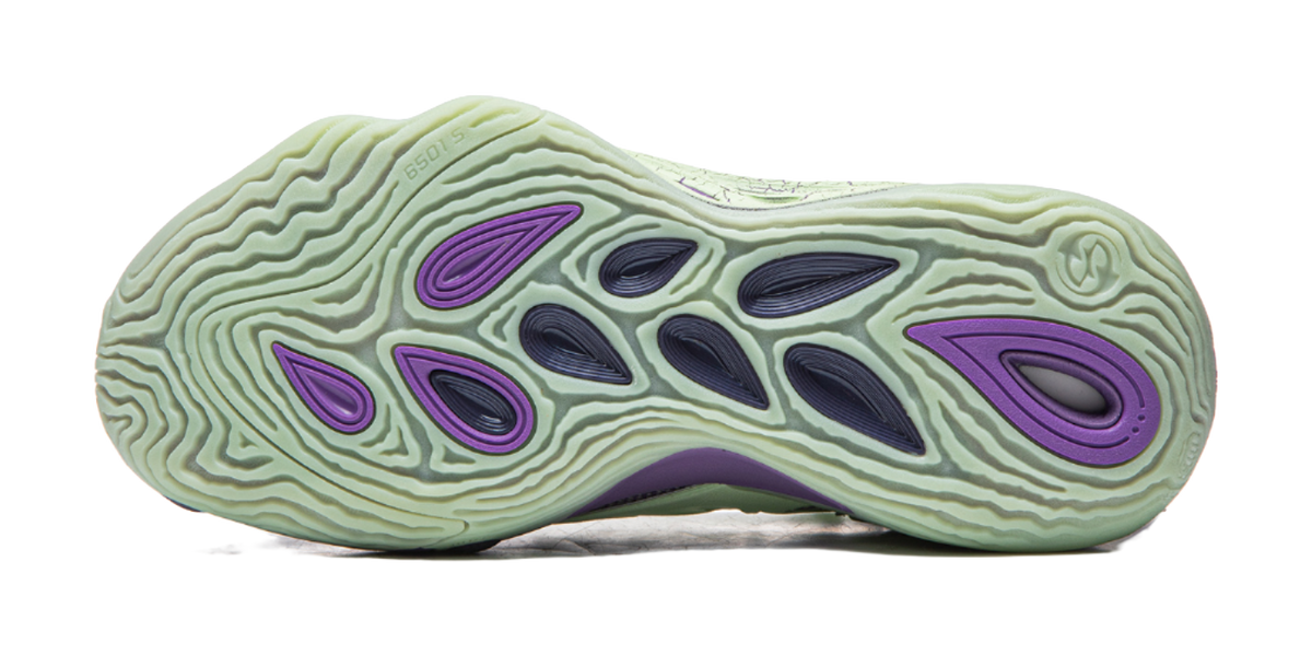 Purple and green basketball shoe outsole with tread pattern on mint rubber