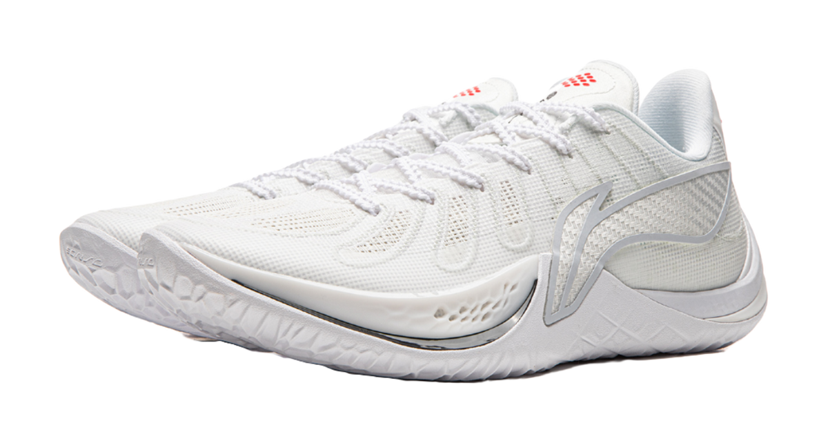 White mesh basketball shoe with lace-up, side logo, and small red logo on tongue.