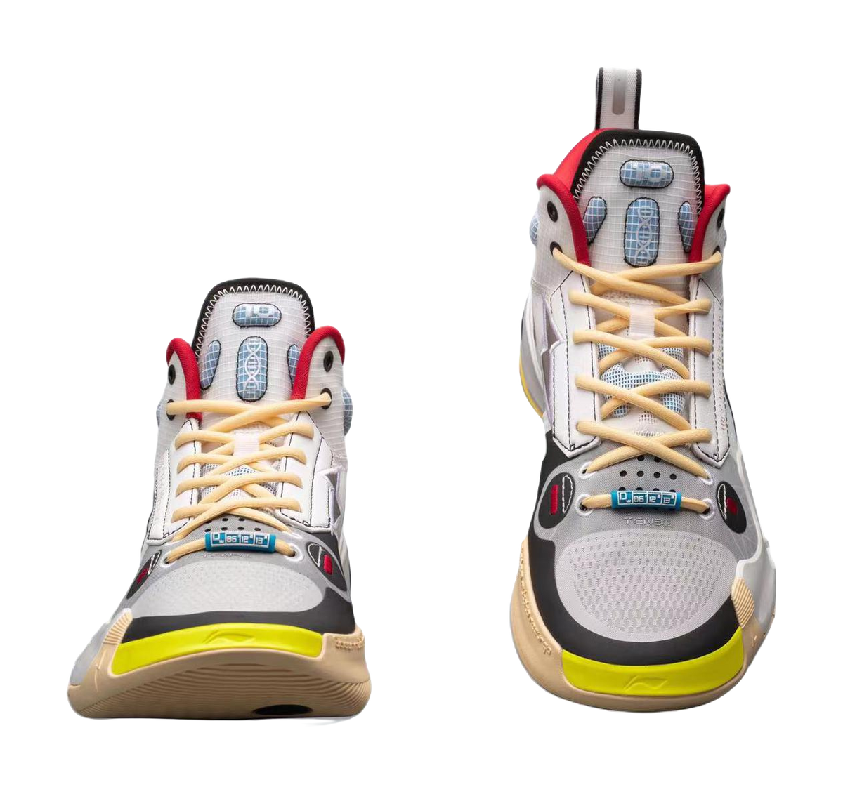 Pair of white mid-top basketball sneakers front view with red trim and yellow outsole