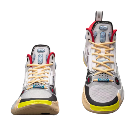 Pair of white mid-top basketball sneakers front view with red trim and yellow outsole