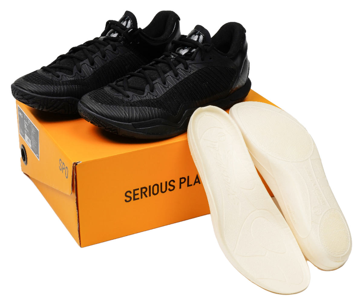 Black low-top basketball shoes with spare light insoles, shown with shoebox.