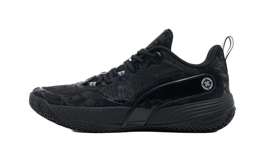 Black basketball shoes with lace-up front, low-cut design, and textured rubber outsole