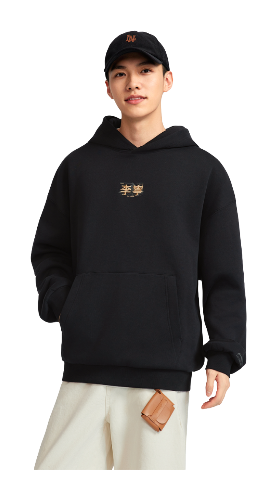 Black hooded fleece-lined pullover worn with light pants