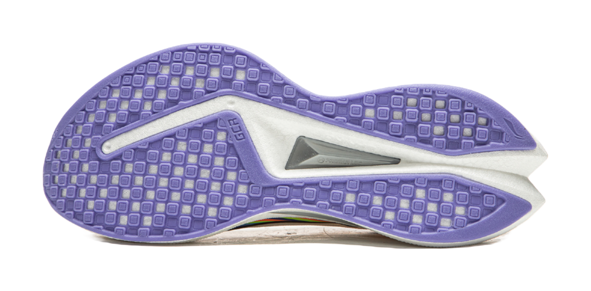Purple treaded outsole of a white running shoe with gray stabilizing insert