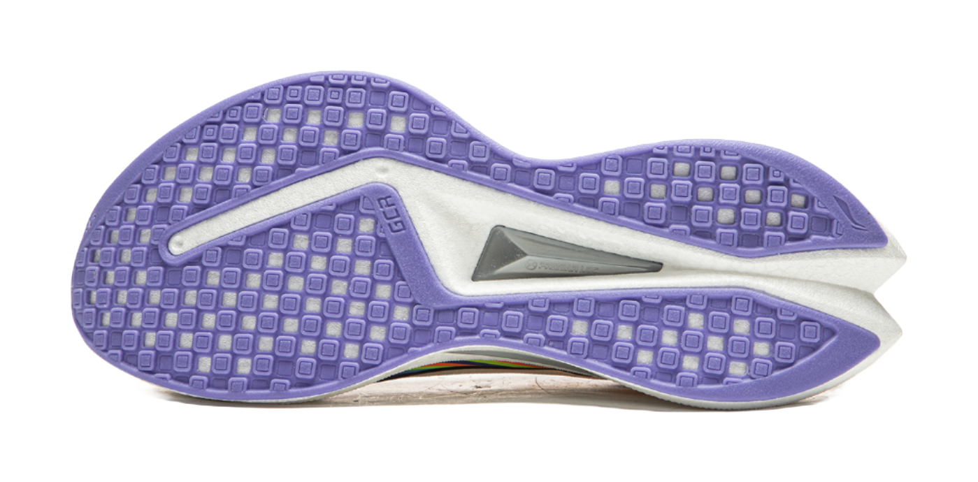 Purple treaded outsole of a white running shoe with gray stabilizing insert