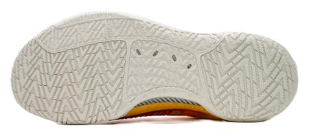 White outsole of multicolor low-top basketball shoes with textured traction pattern