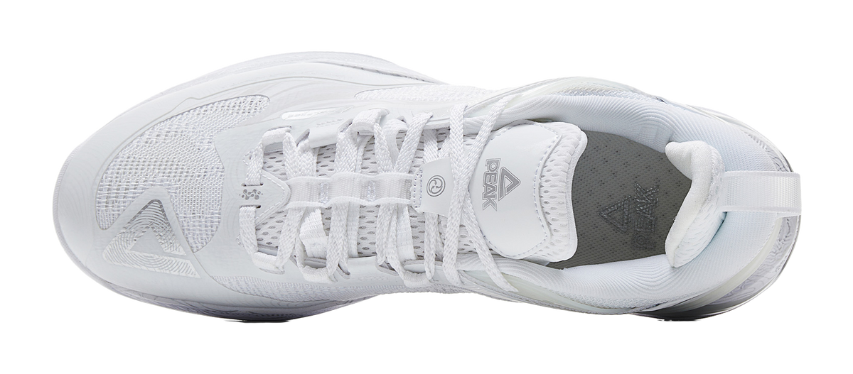 White and silver basketball shoe with laces and mesh upper; view of tongue and heel collar