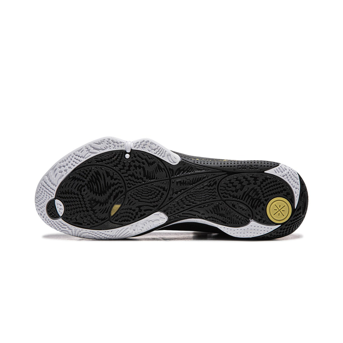 Basketball shoe outsole in black with textured traction and gold circular mark