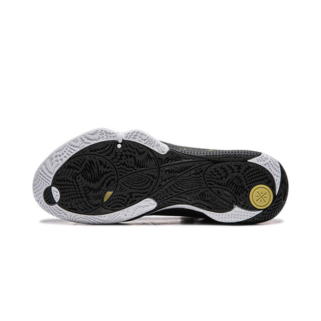 Basketball shoe outsole in black with textured traction and gold circular mark