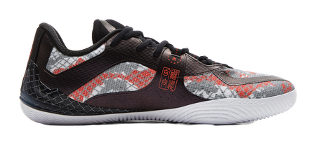 Side view basketball shoe with speckled upper, black overlays, red accents
