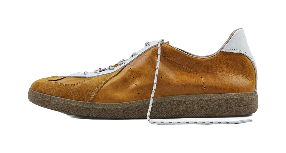 Tan suede low-top sneakers with white leather toe panels and lace-up design