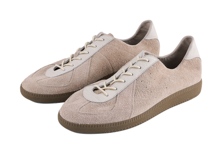 Pair of khaki suede low-top sneakers with white patch details and cream laces