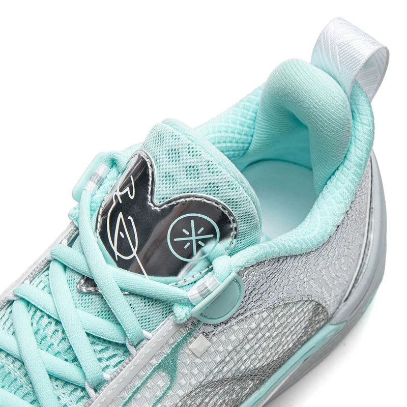 Light blue-gray basketball shoe with teal laces and mesh upper, side graphic detail