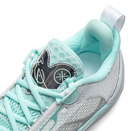 Light blue-gray basketball shoe with teal laces and mesh upper, side graphic detail