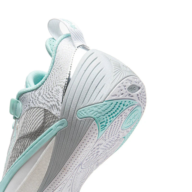 White and light blue-gray basketball shoe with teal accents, patterned sole and heel