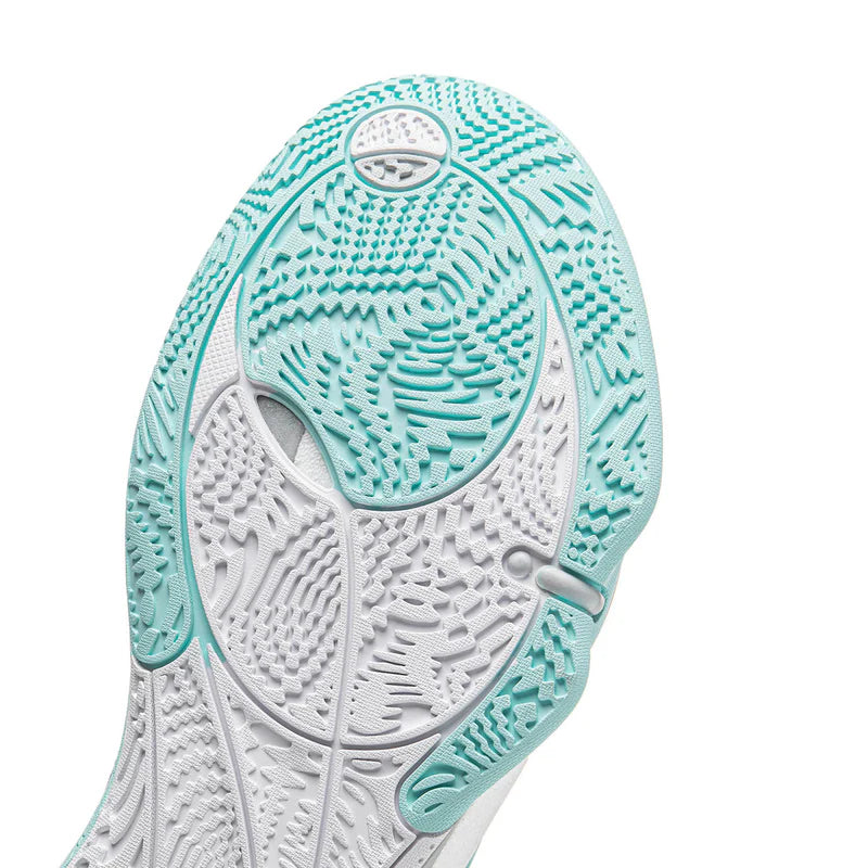 Close-up of shoe outsole with teal and gray tread for grip and cushioning.