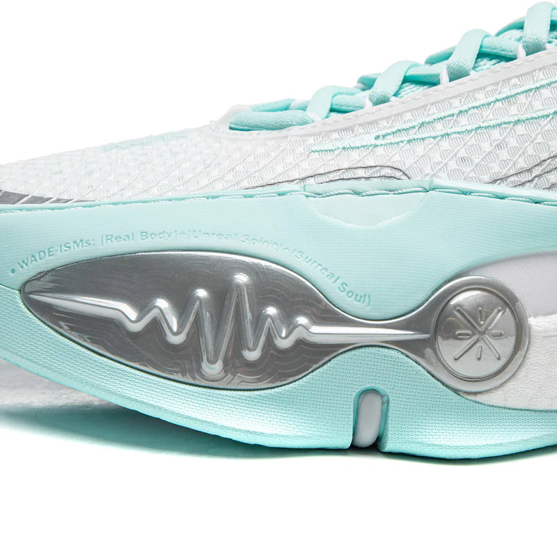 Basketball shoe outsole with metal-like logo plate and teal midsole edge