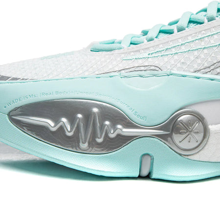 Basketball shoe outsole with metal-like logo plate and teal midsole edge