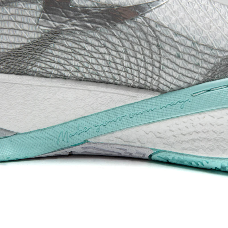 Basketball shoe midsole with teal logo stripe over textured white and gray base
