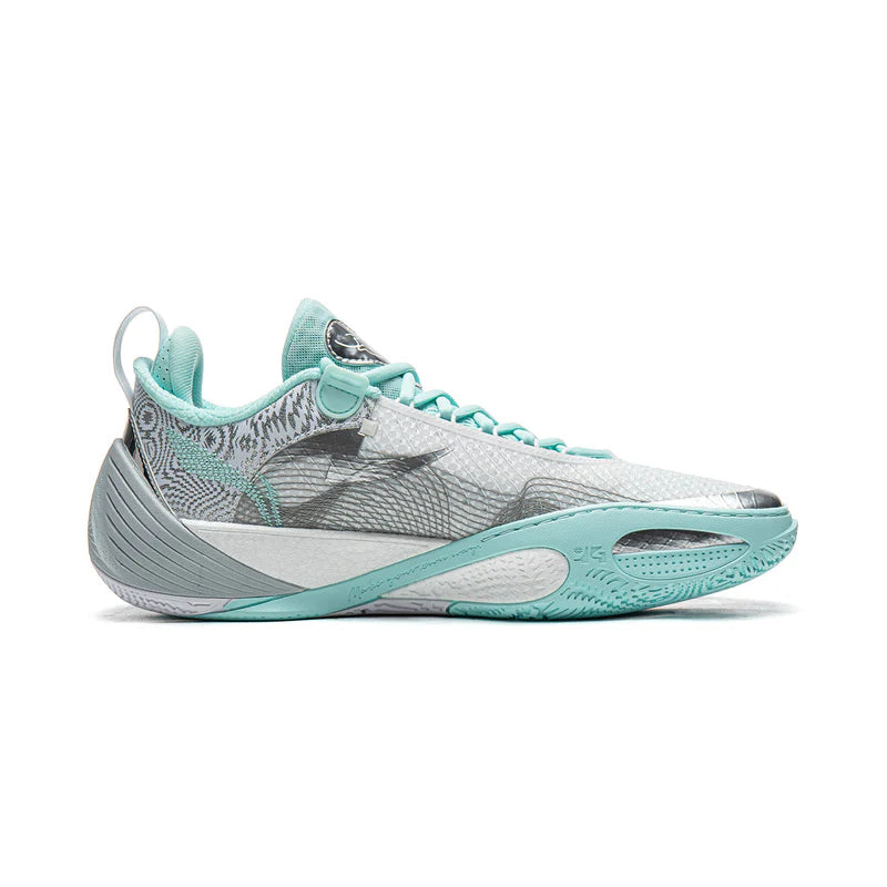 Side view of low-top basketball shoe with gray patterned upper and mint sole accents.