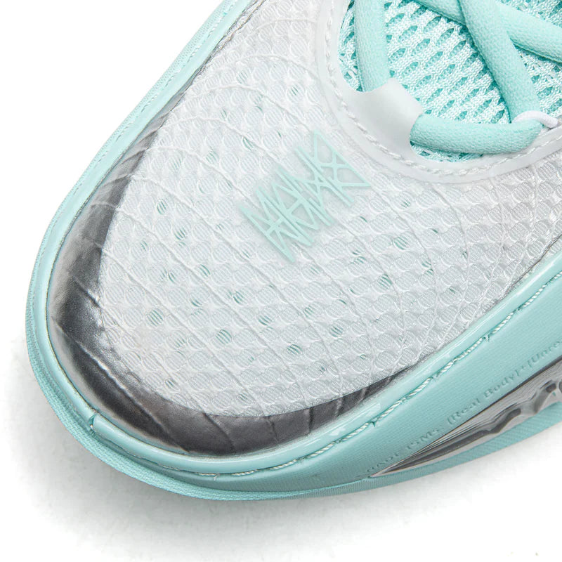 Light blue-gray basketball shoe toe with white mesh texture and teal trim