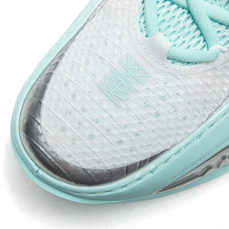 Light blue-gray basketball shoe toe with white mesh texture and teal trim